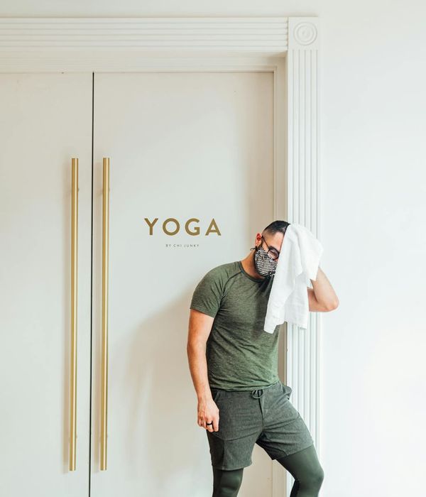 Man in his 40s performing a core strengthening exercise in a bright, clean room.