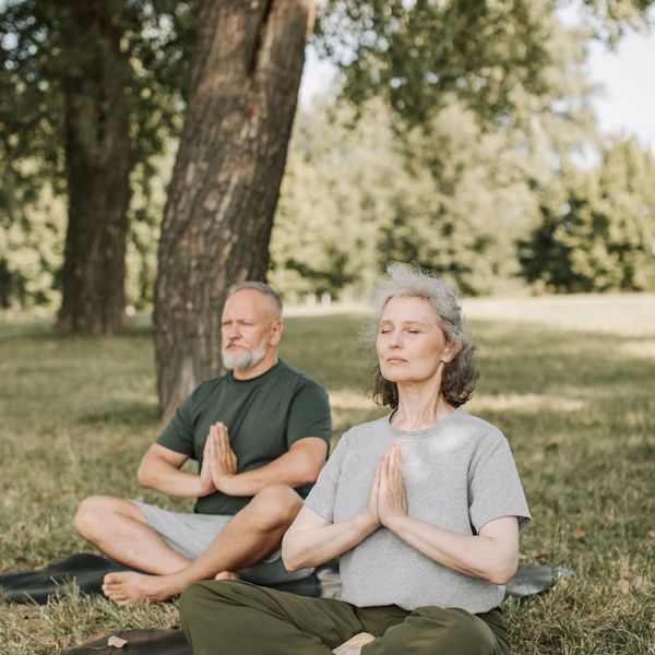 Man meditating outdoors at sunrise feeling peaceful and full of energy.